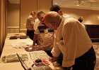 R-L Ralph Constantine, Roger Mallory &#38; George Hernandez looking at 6/27th Yearbook