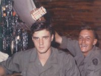 Pete Petras about to be "baptized" by Unknown soldier  Note the Christmas tree  Can you help identify this soldier?